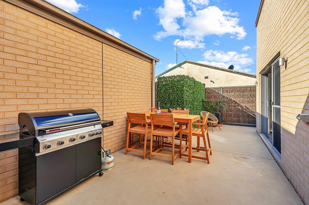 Outdoor courtyard with BBQ and dining area