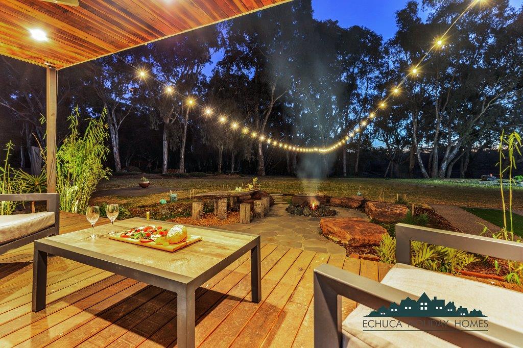 Deck overlooking firepit and dining area